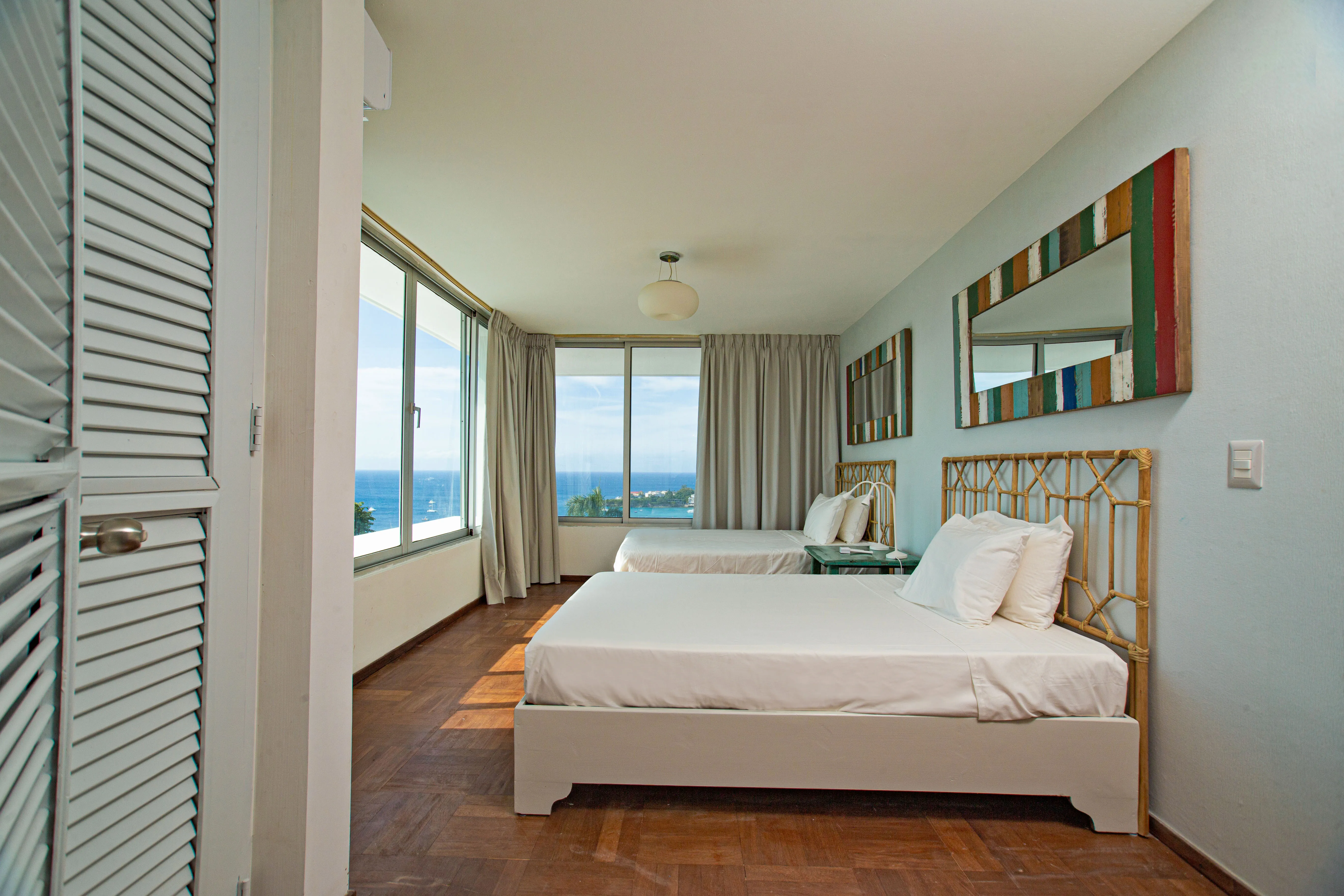 Bedroom 3 with two beds, a wardrobe and ocean-view windows