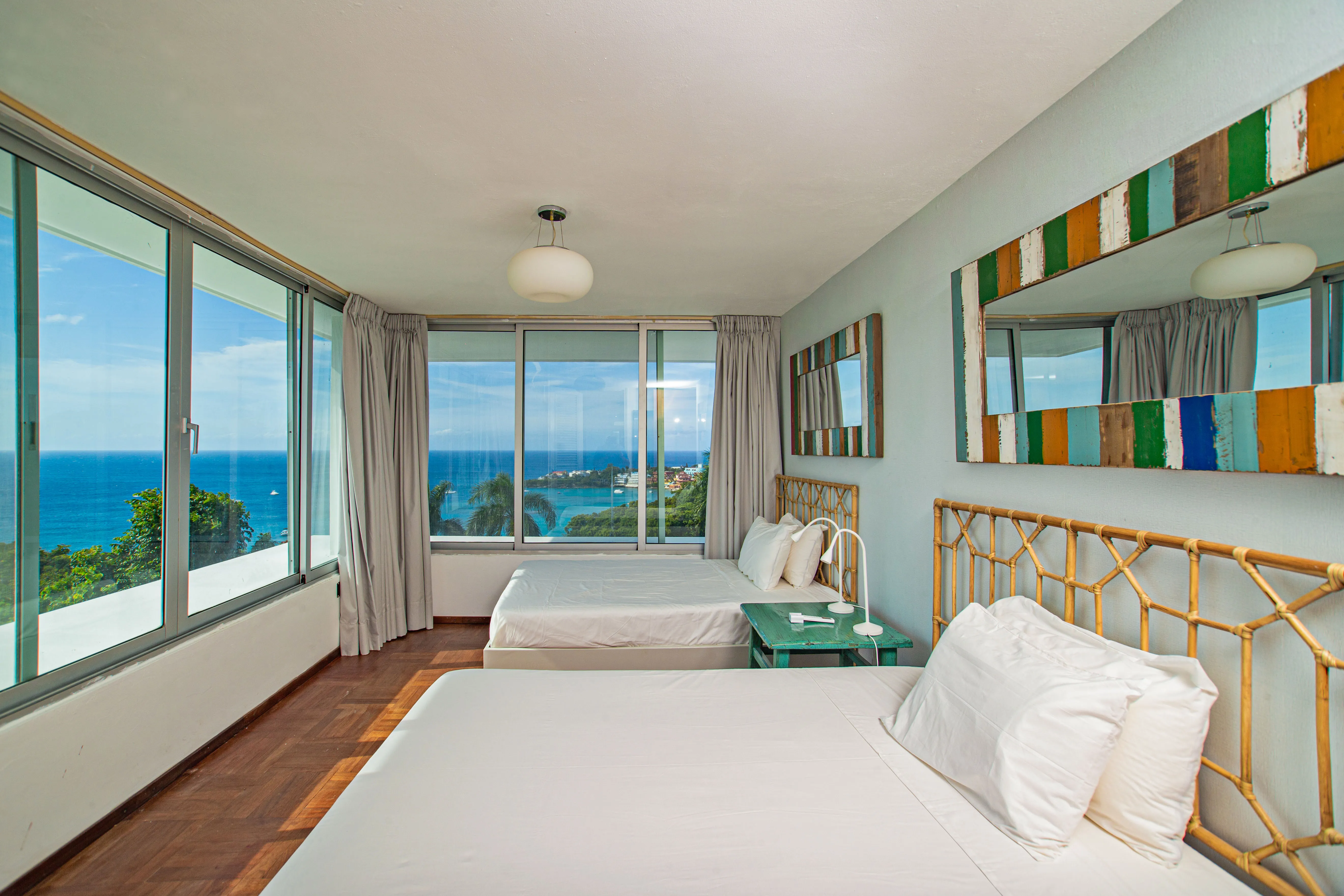 Bedroom 3 with two beds and corner windows over the ocean