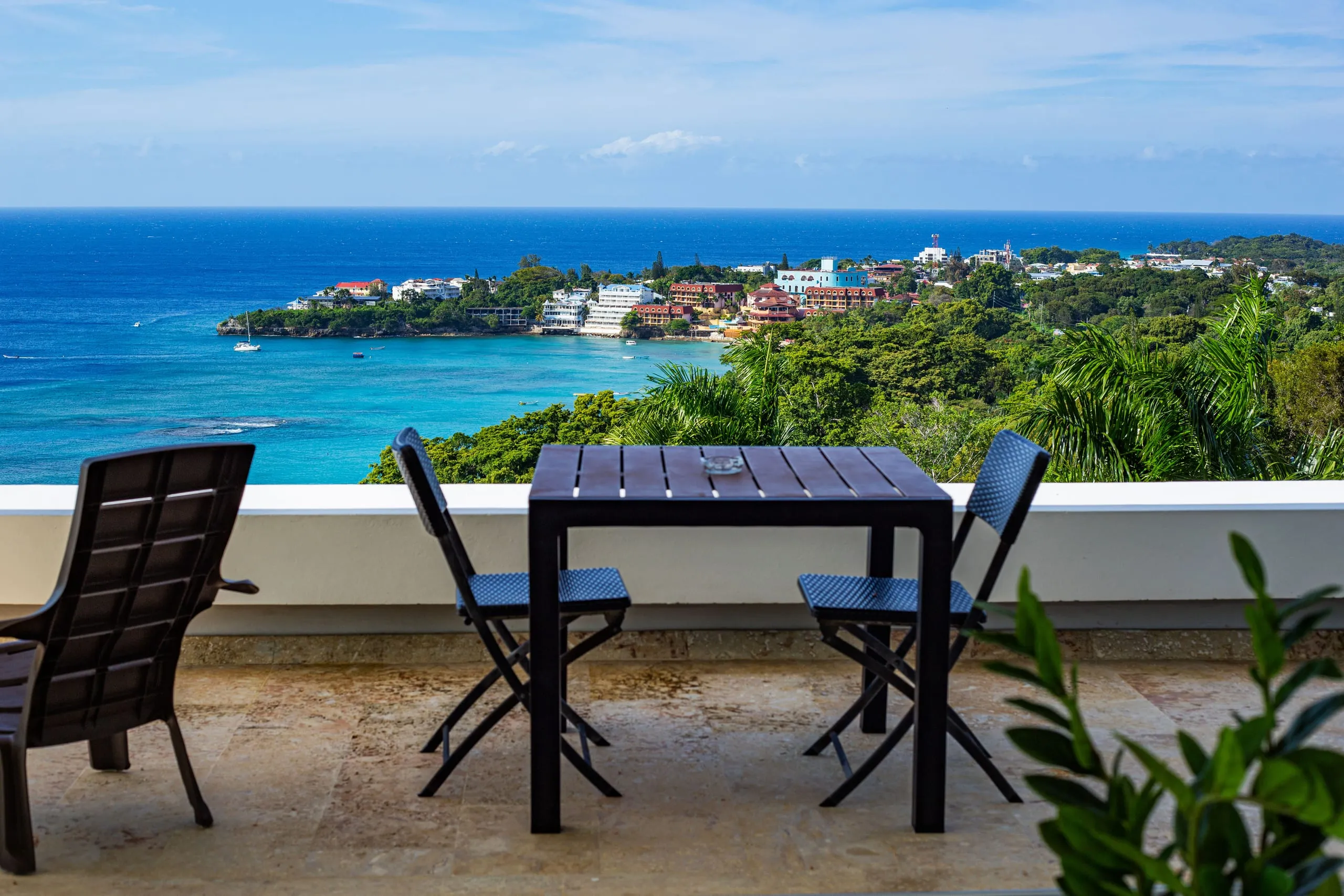 Dining table set against panoramic ocean views