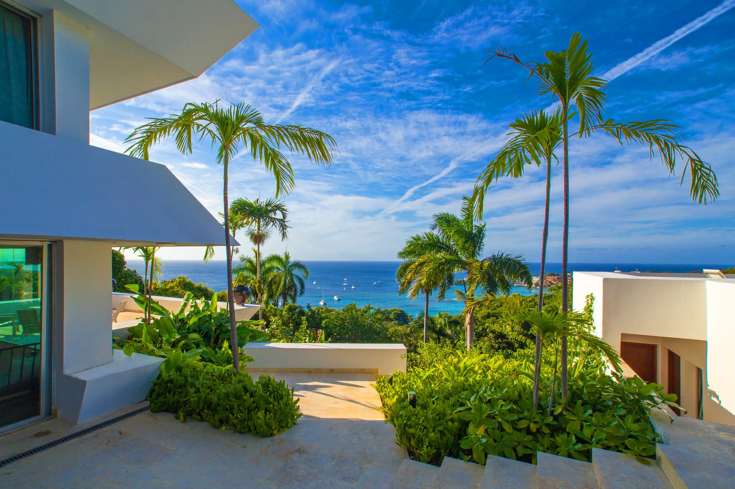 Tropical gardens and palms with the sea beyond