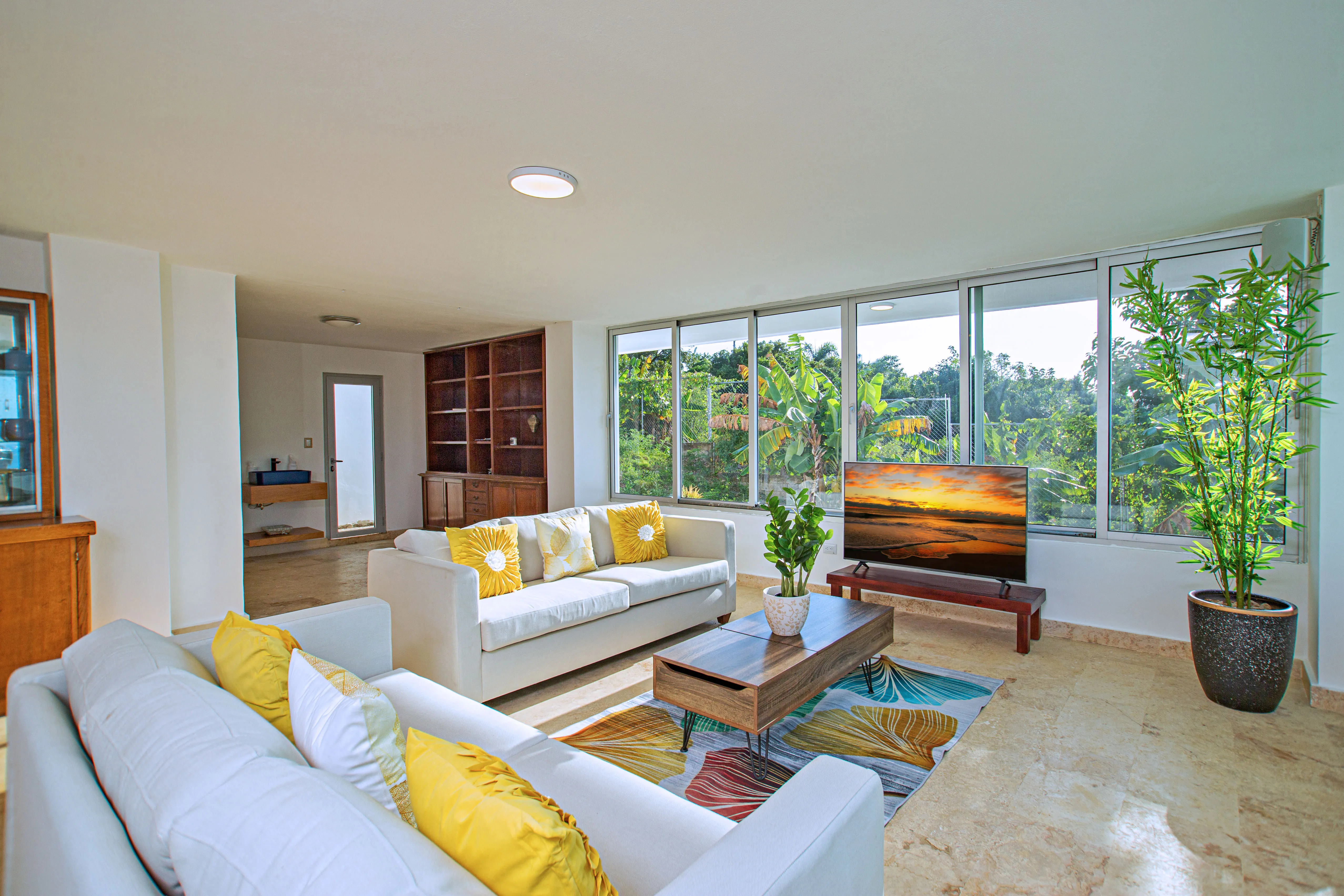 Living room with bright furnishings opening to the garden
