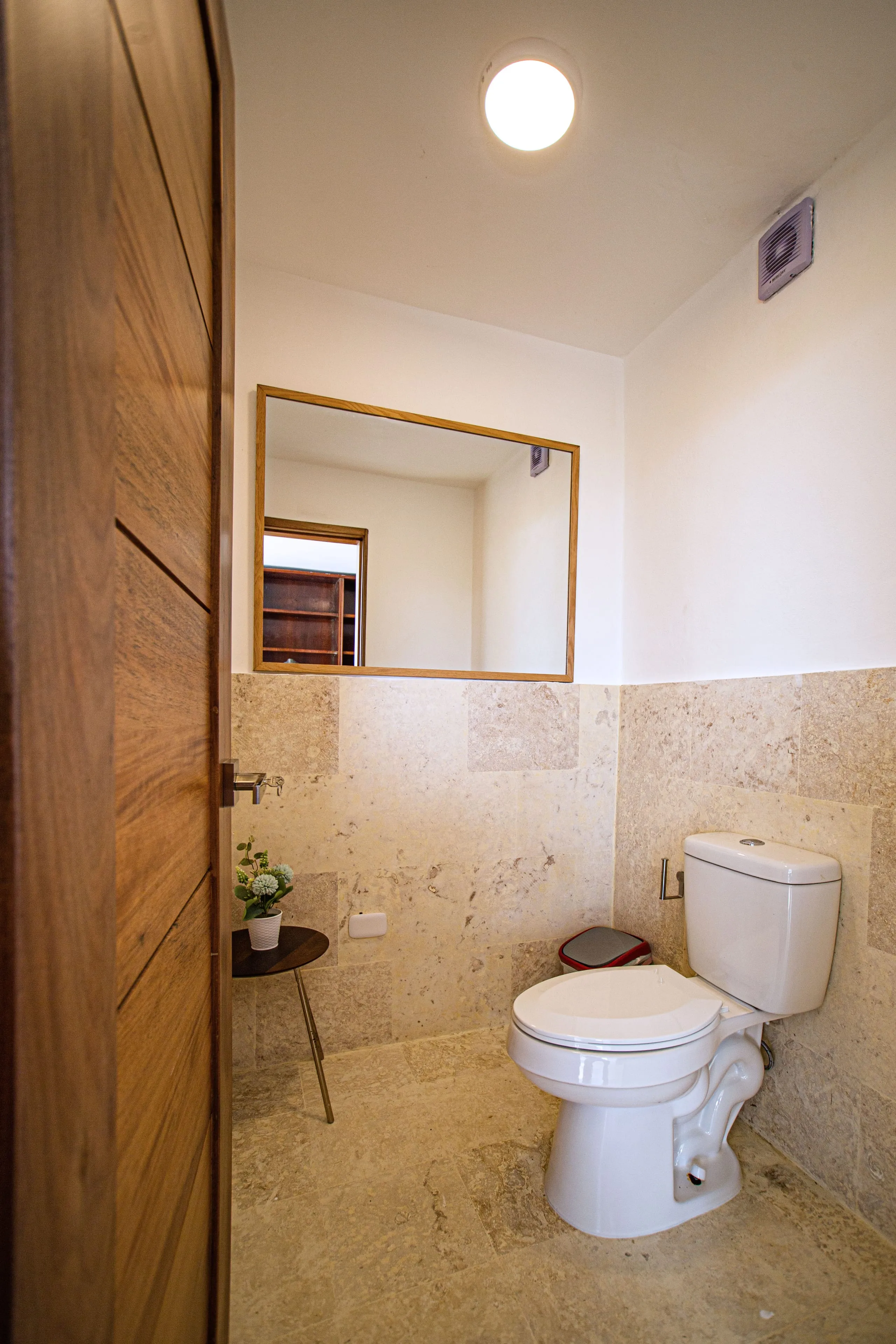 Powder room finished in travertine stone